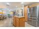 Modern kitchen with stainless steel refrigerator and light wood cabinets at 5695 Merced St, Las Vegas, NV 89148