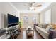 Living room features hardwood floors, a sofa, and a large TV at 5695 Merced St, Las Vegas, NV 89148