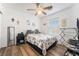 Bedroom with a full bed, ceiling fan, and hardwood floors at 585 Dairy Creek Ave, Las Vegas, NV 89183