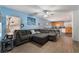 Open living room and kitchen with L-shaped sofa and breakfast bar at 585 Dairy Creek Ave, Las Vegas, NV 89183