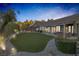 Expansive backyard with a putting green, hot tub, and flagstone pathway at 6336 San Gagano Ave, Las Vegas, NV 89131