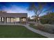 Landscaped backyard with a hot tub and flagstone patio at 6336 San Gagano Ave, Las Vegas, NV 89131