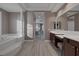 Elegant bathroom with double vanity, soaking tub, and view to bedroom at 6336 San Gagano Ave, Las Vegas, NV 89131