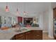 Open kitchen with breakfast bar overlooking living room and access to backyard at 6336 San Gagano Ave, Las Vegas, NV 89131