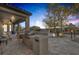 Outdoor kitchen with built-in grill and stone patio at 6336 San Gagano Ave, Las Vegas, NV 89131