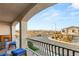 Balcony overlooking the street, complete with a cozy fireplace and outdoor seating at 6595 Creekside Cellars Ct, Las Vegas, NV 89139