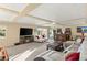 Finished basement with a bar, TV, sectional and view of the backyard at 6595 Creekside Cellars Ct, Las Vegas, NV 89139
