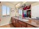 Bathroom featuring double sinks, granite counters, cherry cabinets, and a view overlooking the city at 6595 Creekside Cellars Ct, Las Vegas, NV 89139