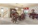 Elegant dining room with a chandelier, hardwood floors, a piano and plenty of room for entertaining at 6595 Creekside Cellars Ct, Las Vegas, NV 89139