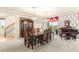 Formal dining room with a large table, ornate chairs, hardwood floors, and a view to the staircase at 6595 Creekside Cellars Ct, Las Vegas, NV 89139