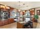 Gourmet kitchen featuring granite countertops, an island, and stainless steel appliances at 6595 Creekside Cellars Ct, Las Vegas, NV 89139