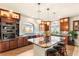 Bright kitchen featuring a large island, stainless steel appliances, and rich wood cabinetry at 6595 Creekside Cellars Ct, Las Vegas, NV 89139