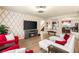 Stylish living room showcasing a fireplace, decorative wallpaper, and a view into the adjacent dining area at 6595 Creekside Cellars Ct, Las Vegas, NV 89139
