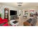 Cozy living room featuring wood floors, a fireplace, and comfortable seating at 6595 Creekside Cellars Ct, Las Vegas, NV 89139
