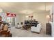 Open living space with a fireplace, chandelier, access to the balcony and lots of natural light at 6595 Creekside Cellars Ct, Las Vegas, NV 89139