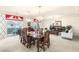 Elegant dining and living room combination with refined furniture, piano and access to the balcony at 6595 Creekside Cellars Ct, Las Vegas, NV 89139