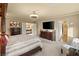 Spacious primary bedroom suite with a comfortable bed, large TV and ample closet space at 6595 Creekside Cellars Ct, Las Vegas, NV 89139