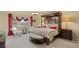 Well-appointed primary bedroom suite showcasing a large bed, stylish seating, and a view from the window at 6595 Creekside Cellars Ct, Las Vegas, NV 89139
