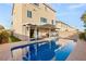 Backyard pool with covered patio for outdoor living and mature landscaping at 6595 Creekside Cellars Ct, Las Vegas, NV 89139