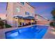 A sparkling blue swimming pool and outdoor patio, perfect for outdoor relaxation and fun at 6595 Creekside Cellars Ct, Las Vegas, NV 89139