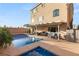 Large pool and spa with covered patio and comfortable seating on a sunny day at 6595 Creekside Cellars Ct, Las Vegas, NV 89139