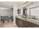 Bathroom with double sinks, granite countertop, and a view of the bedroom at 6617 Breakwater Reef St, Las Vegas, NV 89149