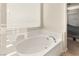 Oval bathtub with tile surround and window at 6617 Breakwater Reef St, Las Vegas, NV 89149