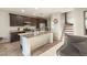 Kitchen with island, granite countertops, and dark cabinets at 6617 Breakwater Reef St, Las Vegas, NV 89149