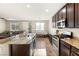 Spacious kitchen featuring granite countertops and dark wood cabinetry at 6617 Breakwater Reef St, Las Vegas, NV 89149