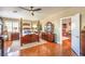 Elegant main bedroom boasting a four-poster bed and hardwood floors at 686 Kentons Run Ave, Henderson, NV 89052