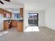 Living room with kitchen, sliding door to patio, and neutral carpeting at 7200 Pirates Cove Rd # 1008, Las Vegas, NV 89145