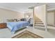 Large bedroom with a comfortable bed and a spiral staircase at 7611 Leybourne Ct, Las Vegas, NV 89131
