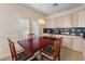 Bright dining area features a wood table with seating for four and access to the kitchen at 7611 Leybourne Ct, Las Vegas, NV 89131