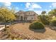 Two-story house with tan siding, landscaping, and a palm tree in the front yard at 7611 Leybourne Ct, Las Vegas, NV 89131