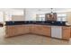 Large kitchen island with granite countertops and a breakfast bar at 7611 Leybourne Ct, Las Vegas, NV 89131