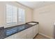 Laundry room with granite countertop and shelving at 7611 Leybourne Ct, Las Vegas, NV 89131