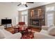 Spacious living room with stone fireplace, hardwood floors, and ample natural light at 7611 Leybourne Ct, Las Vegas, NV 89131