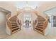 Grand double staircase with wooden railings at 7611 Leybourne Ct, Las Vegas, NV 89131