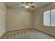 Carpeted bedroom with ceiling fan and window at 8904 Martin Downs Pl, Las Vegas, NV 89131