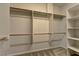 Spacious walk-in closet with shelves and hanging rods at 8904 Martin Downs Pl, Las Vegas, NV 89131