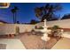 Landscaped backyard with fountain and seating area at 9109 Lazy Hill Cir, Las Vegas, NV 89117