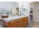 Bathroom featuring double sinks, tile countertop, and wood cabinets at 9109 Lazy Hill Cir, Las Vegas, NV 89117