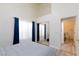 Bright bedroom with high ceilings, a sliding mirror closet, and light-colored floors at 9109 Lazy Hill Cir, Las Vegas, NV 89117