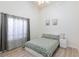 Well-lit bedroom with a large window, neutral walls, and wood-look flooring at 9109 Lazy Hill Cir, Las Vegas, NV 89117