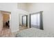 Bedroom with a sliding mirror closet and view into another bedroom at 9109 Lazy Hill Cir, Las Vegas, NV 89117