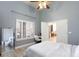 Serene bedroom featuring a workspace, shutters, and plenty of natural light at 9109 Lazy Hill Cir, Las Vegas, NV 89117