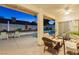 Covered patio features a seating area with views of the pool and landscaped backyard at 9109 Lazy Hill Cir, Las Vegas, NV 89117