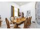 Beautifully decorated formal dining room with tall ceilings, eye-catching art, and large wooden table for entertaining at 9109 Lazy Hill Cir, Las Vegas, NV 89117