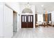 Spacious foyer with soaring ceilings, striking light fixture, and views into the formal living room at 9109 Lazy Hill Cir, Las Vegas, NV 89117