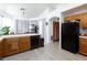 Kitchen with oak cabinets, white countertops and stainless-steel refrigerator at 9109 Lazy Hill Cir, Las Vegas, NV 89117